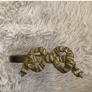 Brass bow curtain tie back